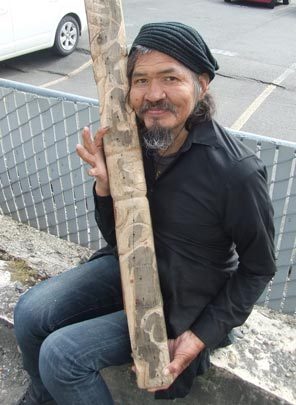 John T. Willaims holding his carving work